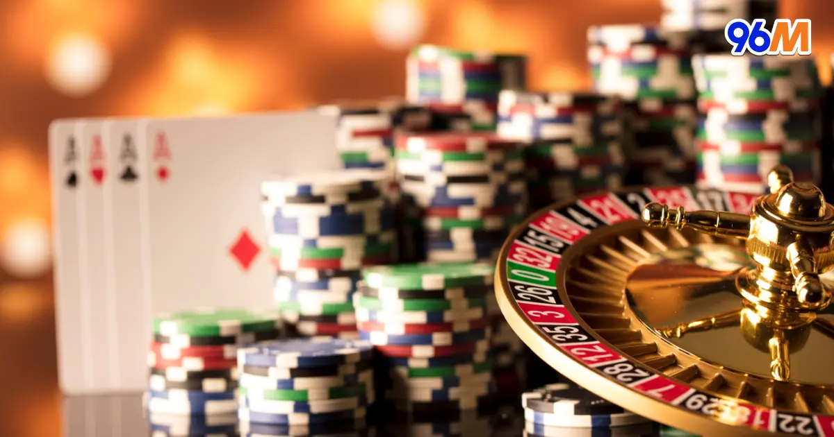 Casino roulette wheel with poker chips and playing cards, representing live casino games at 96M Malaysia