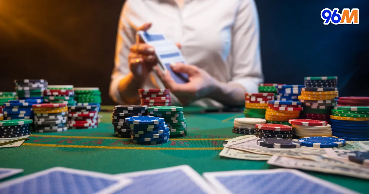 Live dealer handling cards with poker chips and cash on casino table at 96M Malaysia online casino